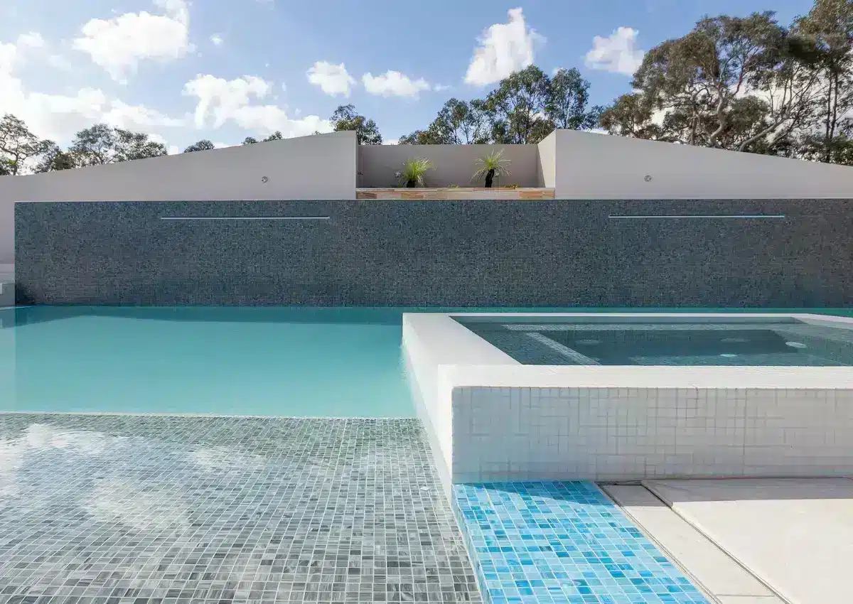Detail of an in-ground concrete swimming pool with clean waterline and modern finishes in Castlereagh, NSW