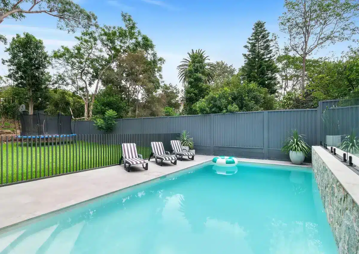 In-ground concrete pool with open garden views and modern fencing in the Garden Vista project, NSW