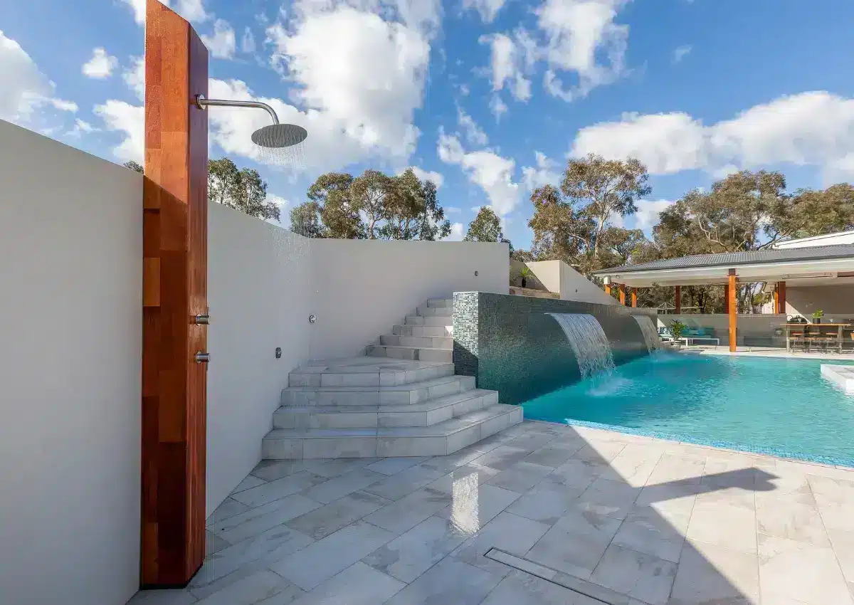 Modern in-ground concrete pool with stone paving and open outdoor space in Castlereagh, NSW