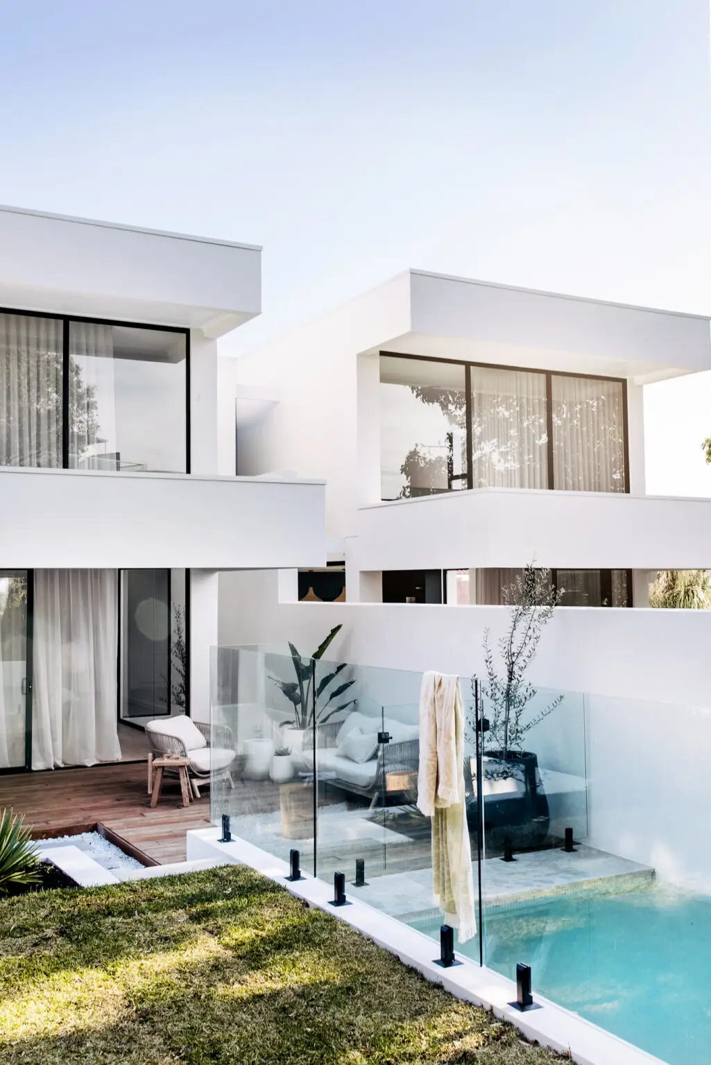 Modern in-ground concrete pool with glass fencing and contemporary residential architecture at the Duple project