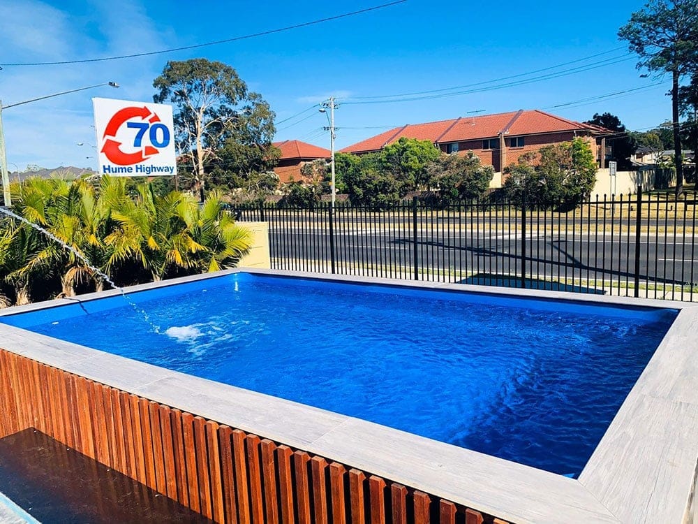 Above ground pool installation in a Sydney backyard with raised fencing and modern landscaping