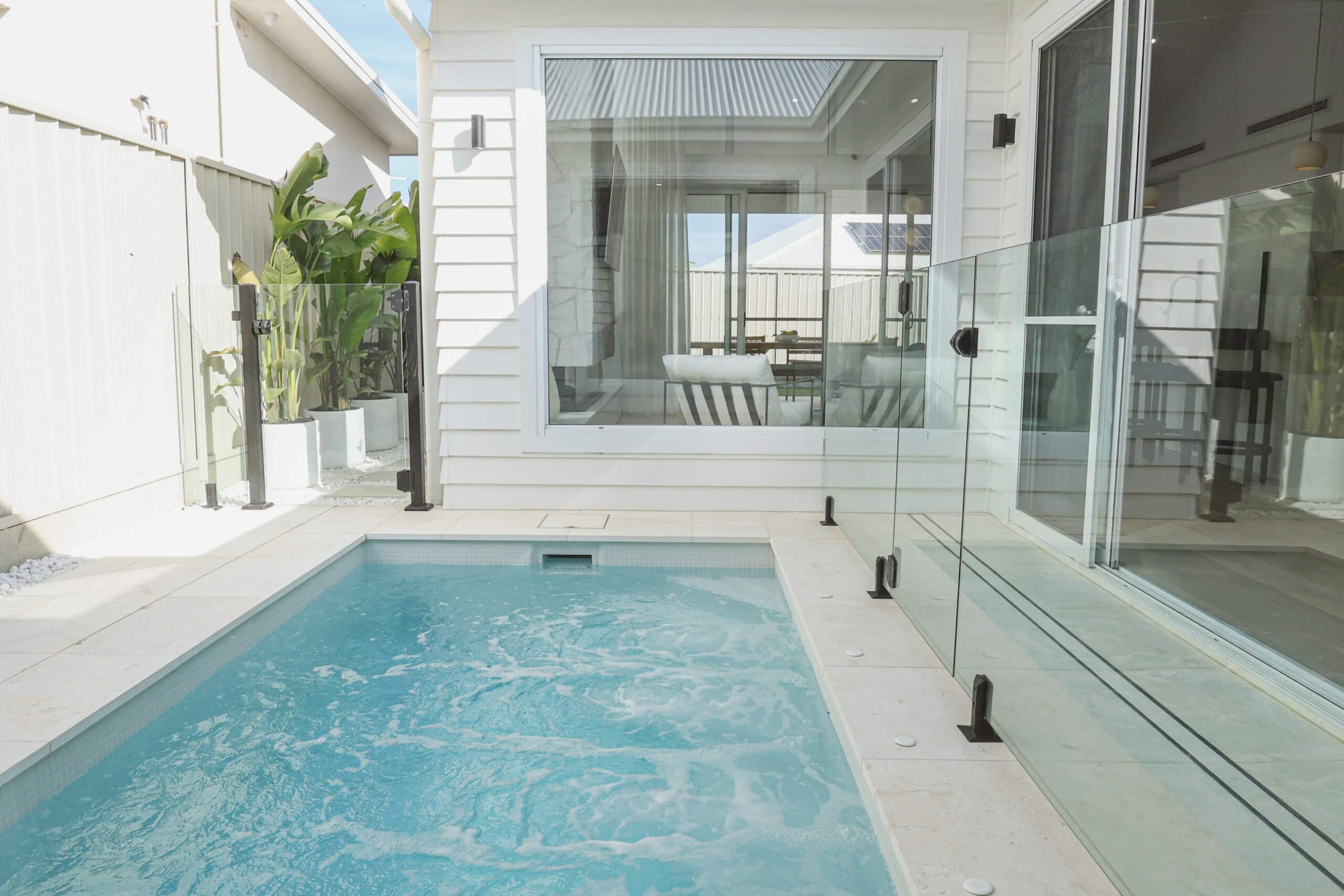 Modern concrete plunge pool showing luxury outdoor living in a compact backyard