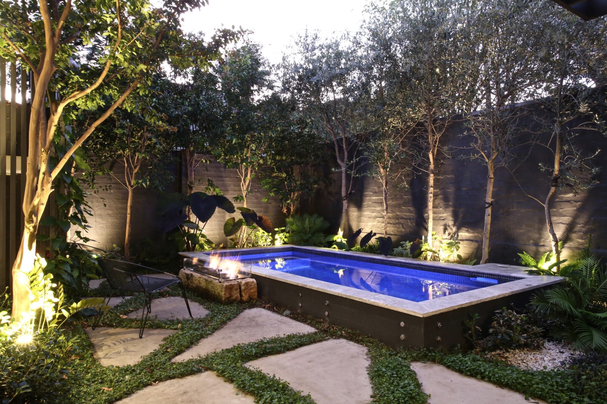 Architectural concrete pool at night with ambient lighting in Bondi Junction, Sydney, by Blue Haven Pools