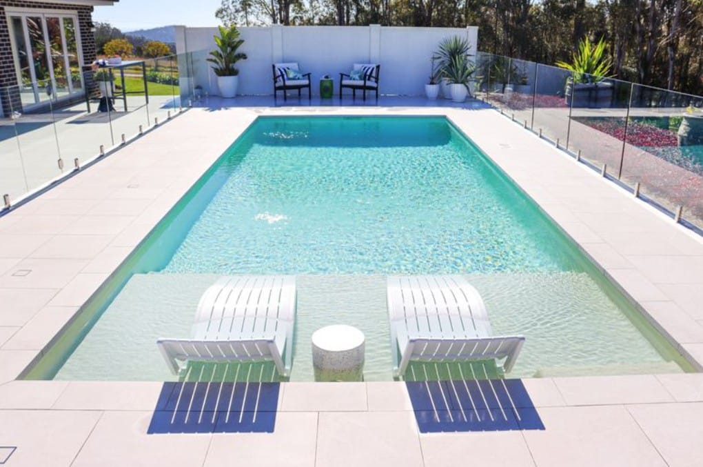 Shallow wet deck pool area designed for lounging and relaxation