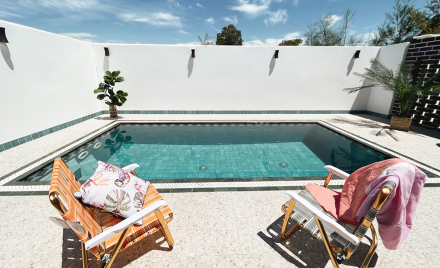 Modern plunge pool in a small Sydney backyard with outdoor seating and clean landscaping
