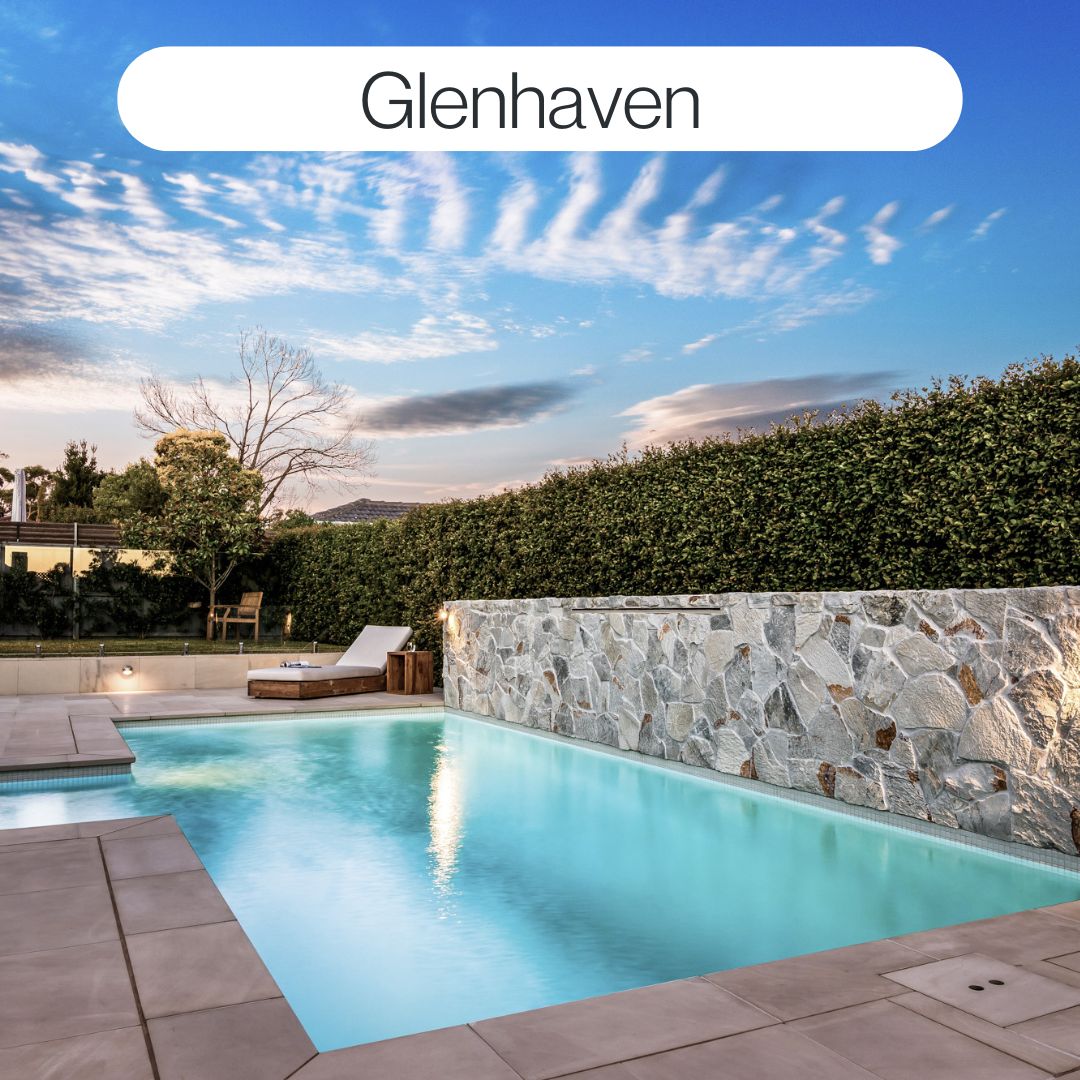 Custom backyard swimming pool in Glenhaven with stone feature wall, modern paving and resort-style outdoor living design