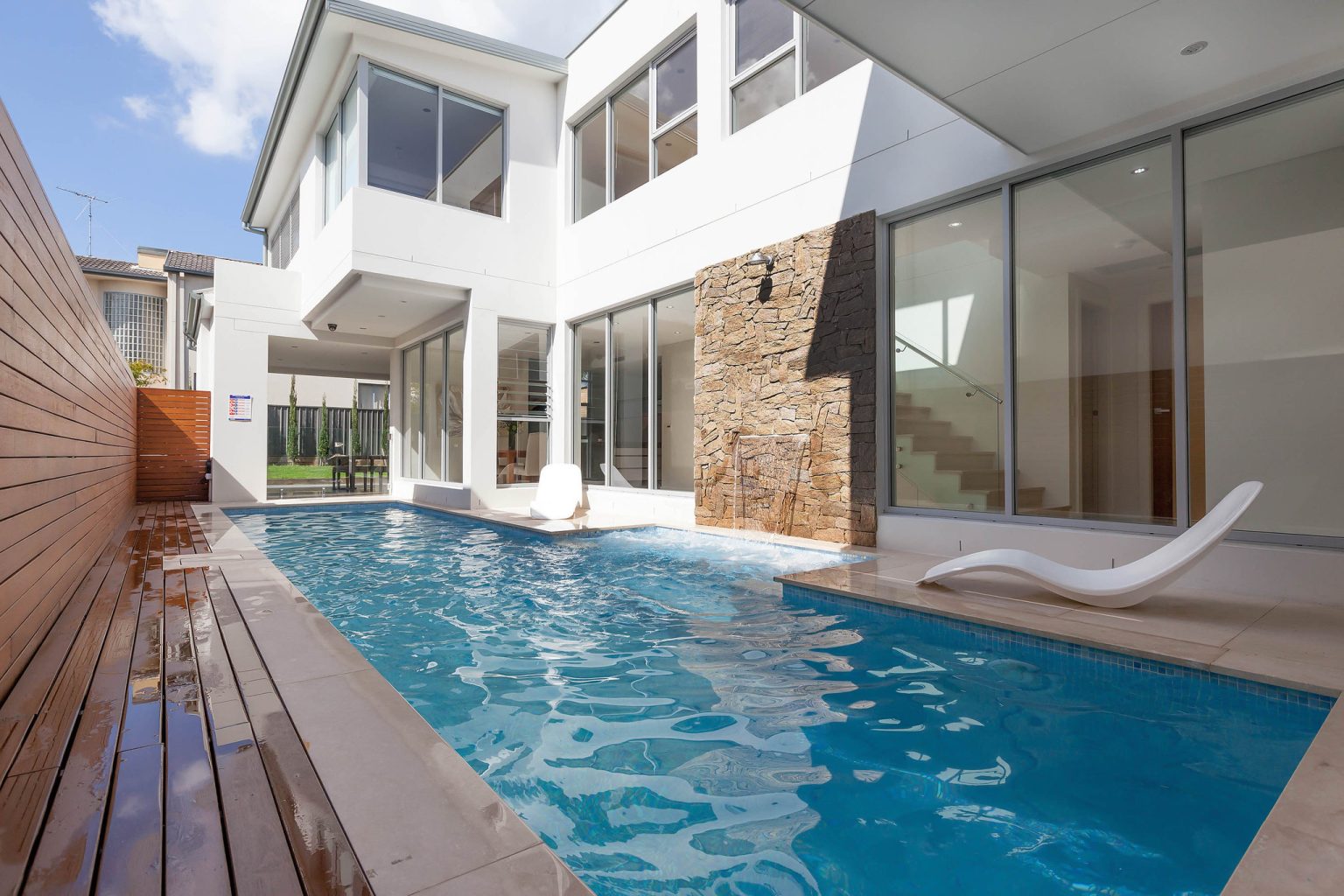 Travertine coping around a modern custom concrete pool in South Hurstville NSW
