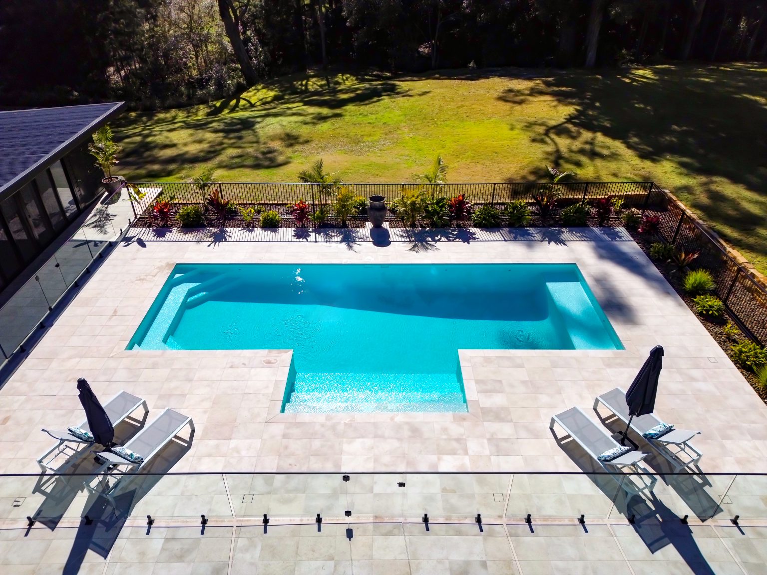 Side open bubble spa with mini spa jets connected to luxury concrete pool in Empire Bay NSW
