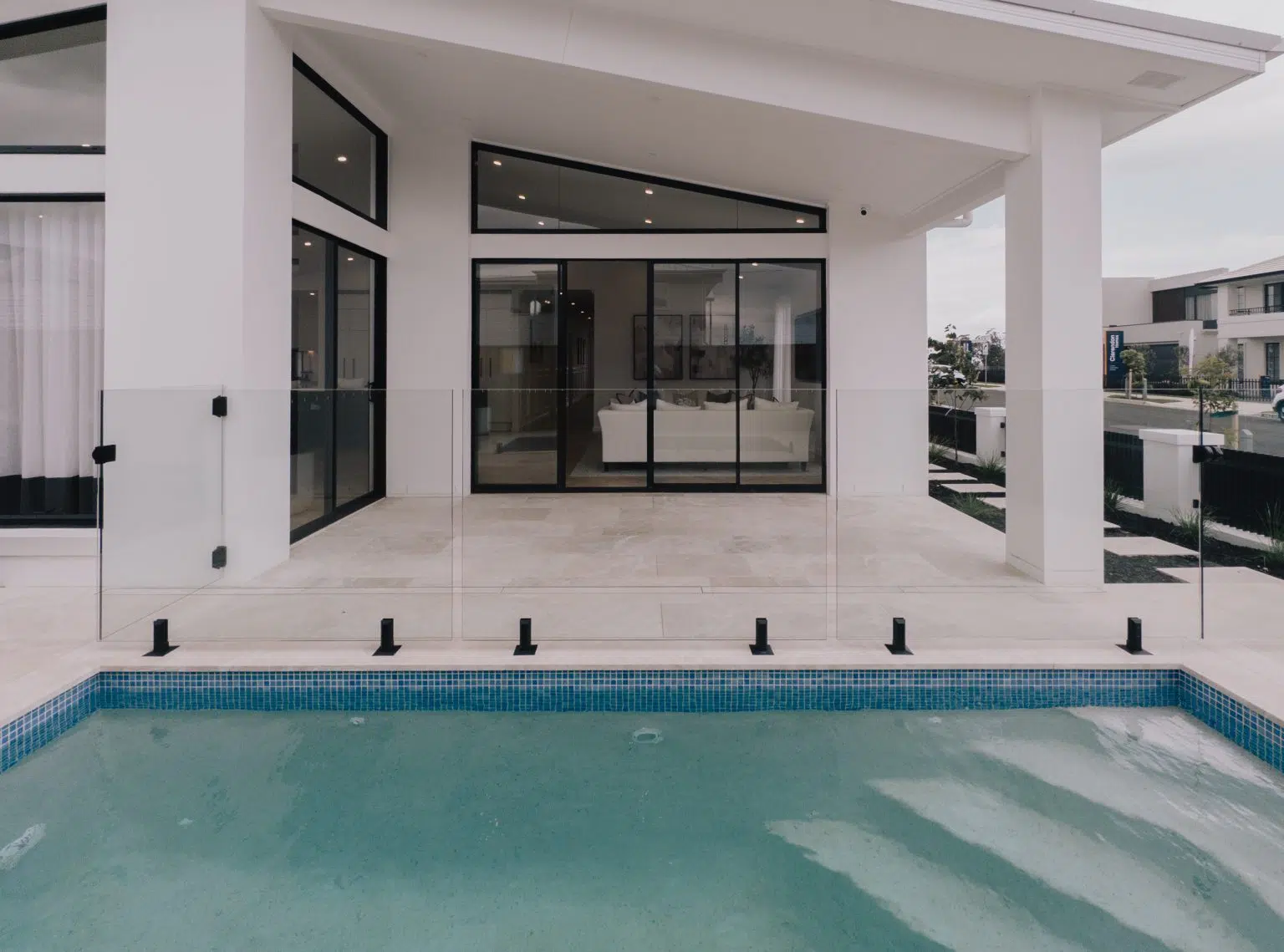 Custom concrete display home pool built for Allcastle Homes in Oran Park by Blue Haven Pools