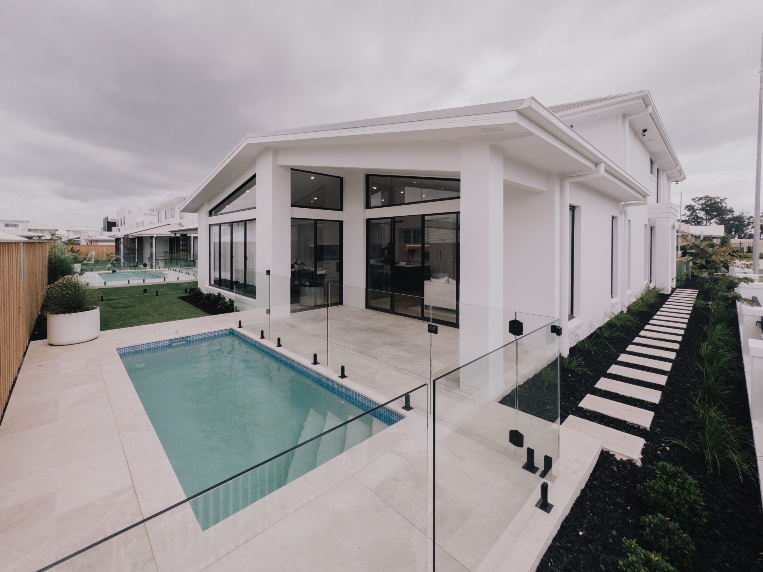 Modern new home with an integrated swimming pool and outdoor entertaining area