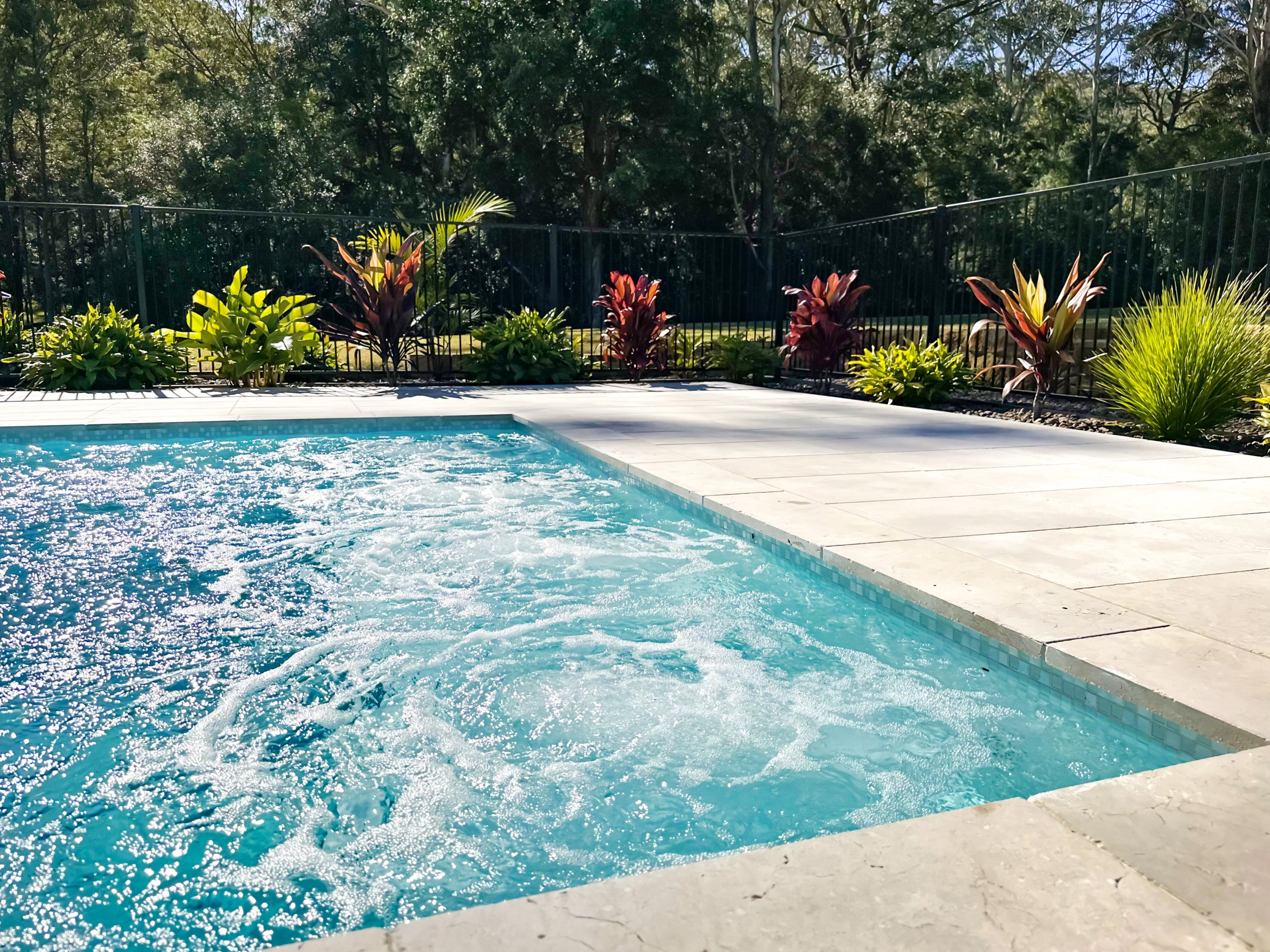 Custom backyard swimming pool designed for relaxed coastal living