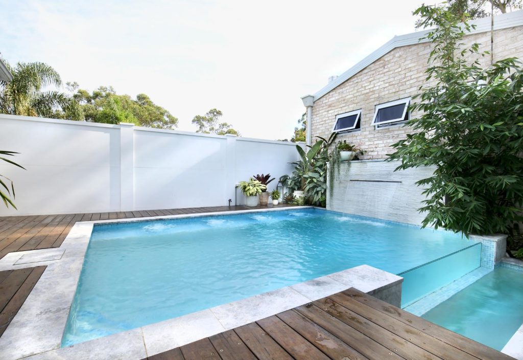 Modern infinity edge pool with clean lines, timber decking and private backyard design