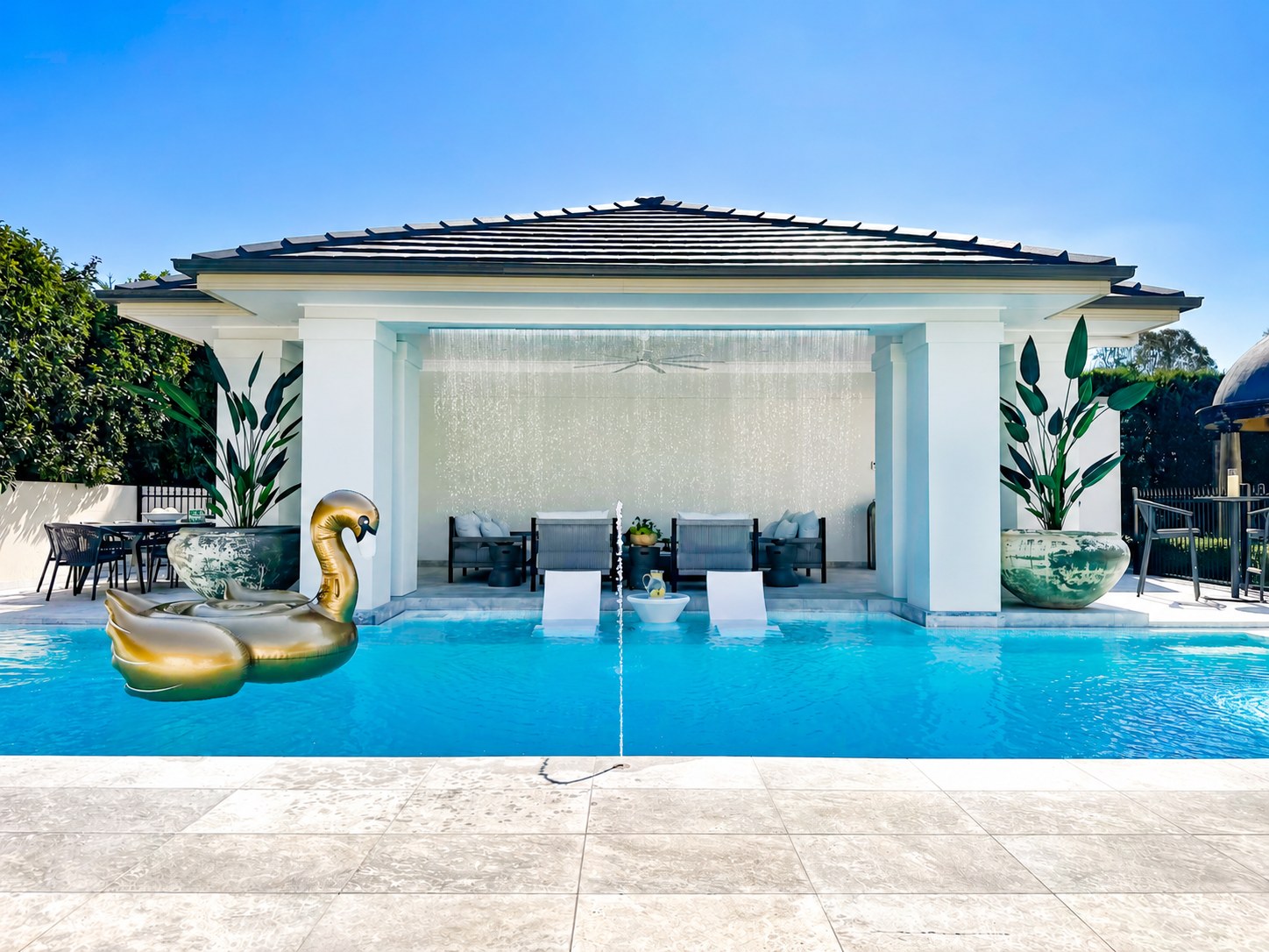 Luxury concrete pool with natural stone feature wall and sheer descent waterfalls in Catherine Fields