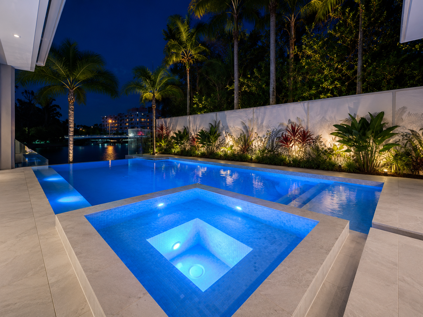 Swimming pool and spa illuminated with blue LED lights in a Sydney backyard