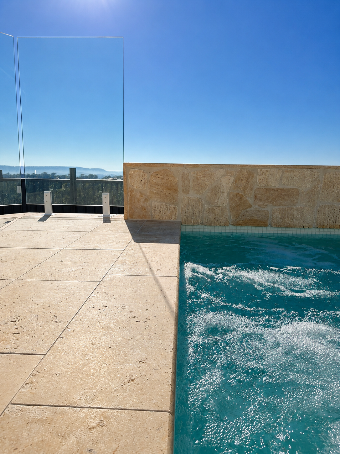 Modern swimming pool with tiled feature wall and architectural tile detailing